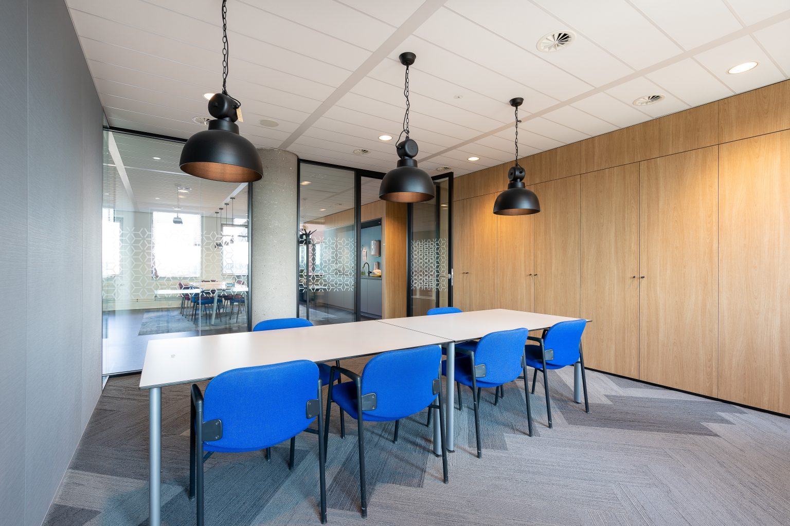Modern office meeting room with long timber table after refurbishment