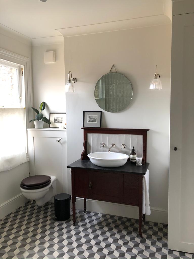 Cloakroom with vintage washstand, vessel basin and chequerboard floor, Clairville Gardens W7