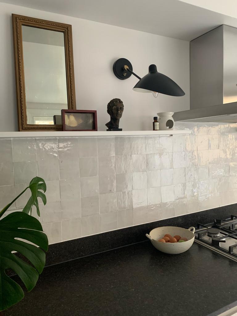 Handmade look white tiles, black worktop and floating shelf with black wall light, Hanwell kitchen