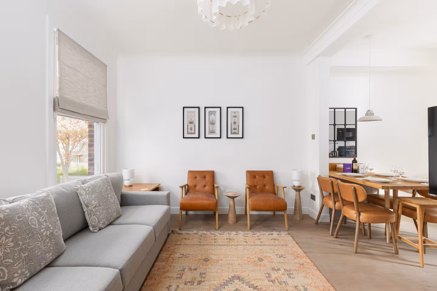 Living room with grey sofa, window seat and dining area beyond, St John's Wood refurbishment