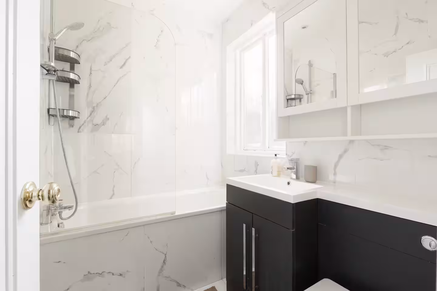 Bathroom with marble effect tiles, dark vanity unit and bath with shower, Allitsen Road NW8