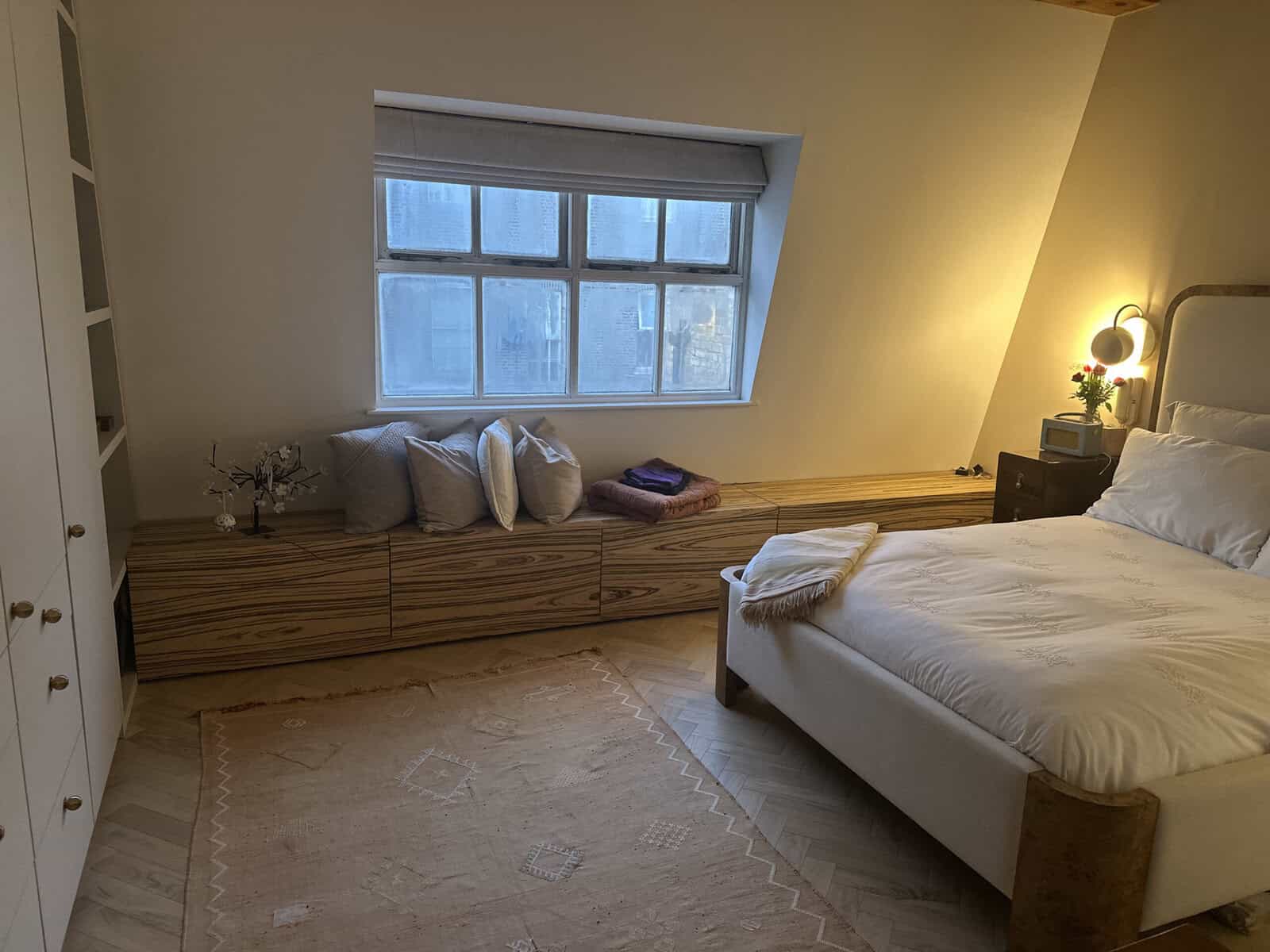 Bedroom with fitted window seat, sloping ceiling and herringbone floor, Hanover Place Bow