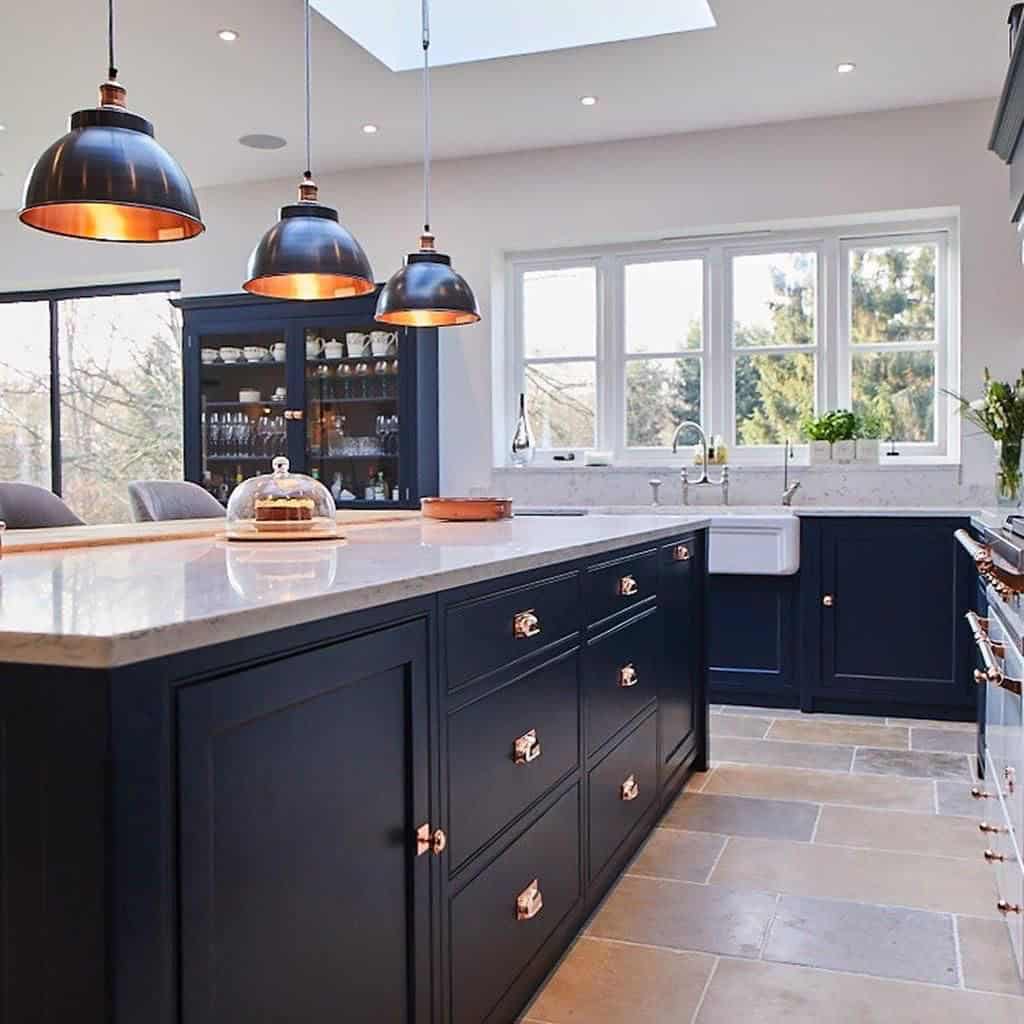 Navy shaker kitchen island with copper pendants, Belfast sink and stone floor, Meadway Close NW11