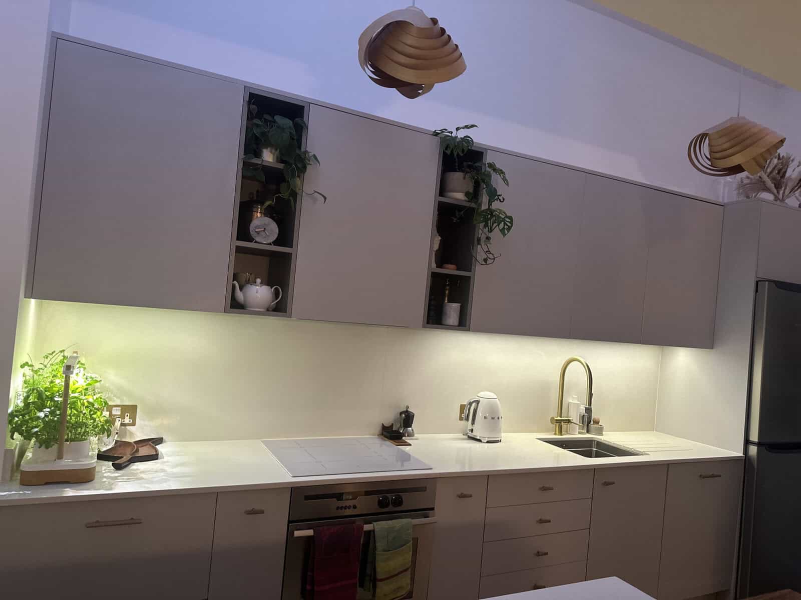 Handleless kitchen with open shelving and under cabinet lighting, Bow house renovation