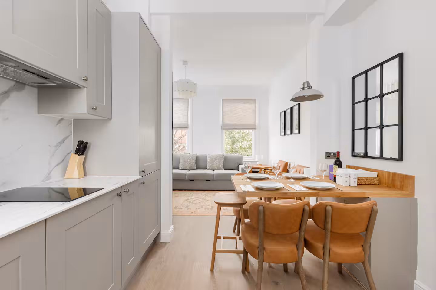 Pale grey shaker units with marble effect splashback and induction hob, looking through to the living room, Allitsen Road NW8