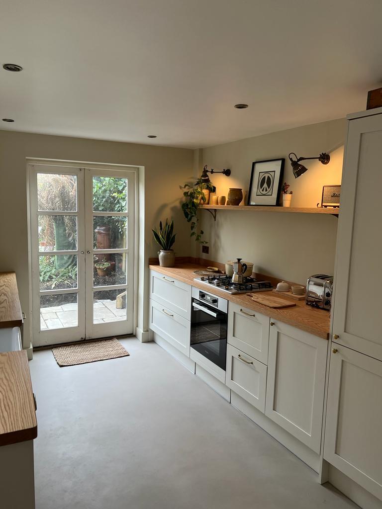 Galley shaker kitchen with oak worktops leading to French doors onto the garden, Hanwell kitchen renovation