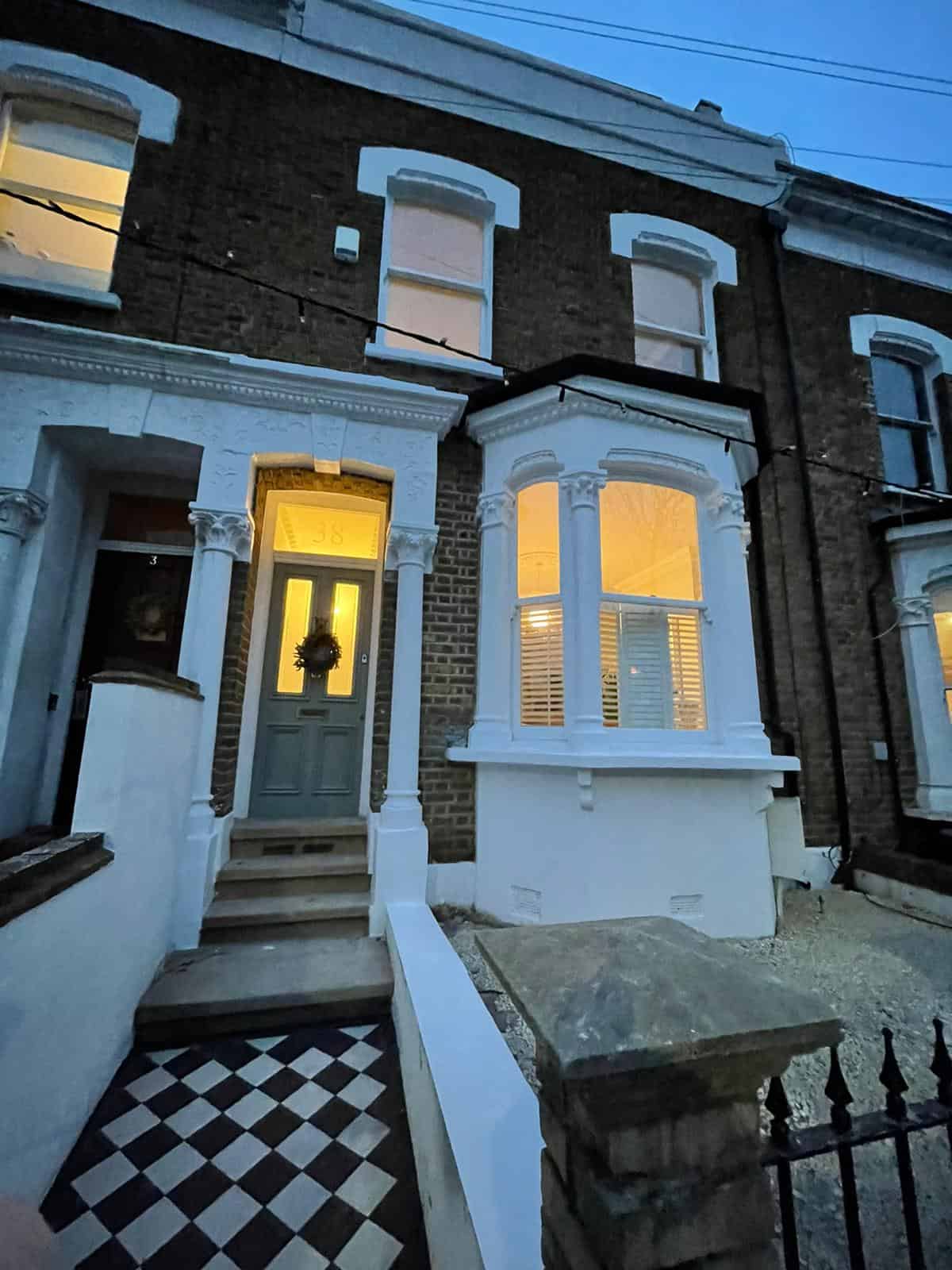 Victorian terrace front with chequerboard path at dusk, Corbyn Street N4